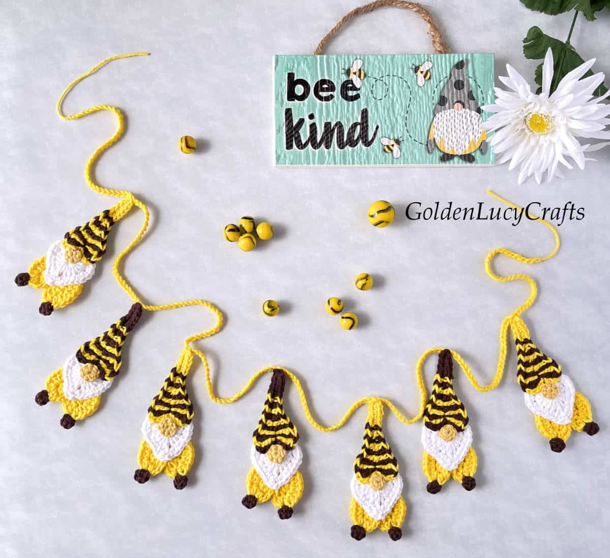 Crochet bee gnome garland, sign saying Bee Kind.