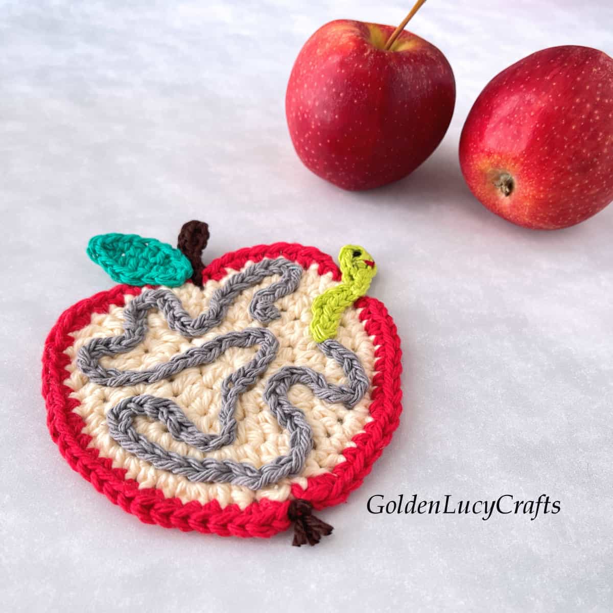 Crochet apple with worm applique.