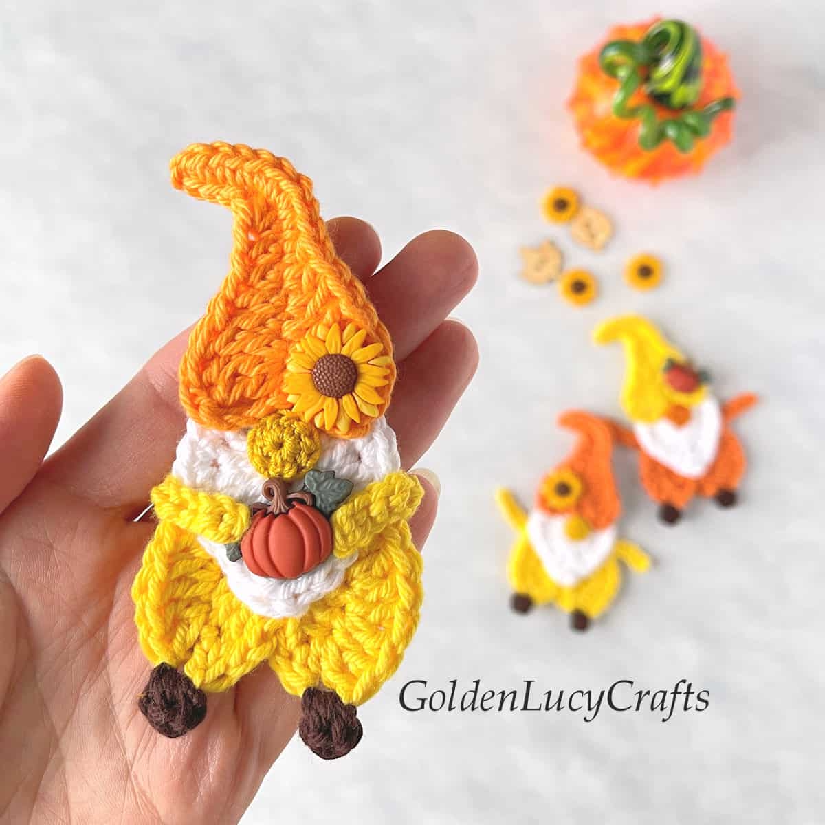 Crochet Fall gnome in the palm of a hand.