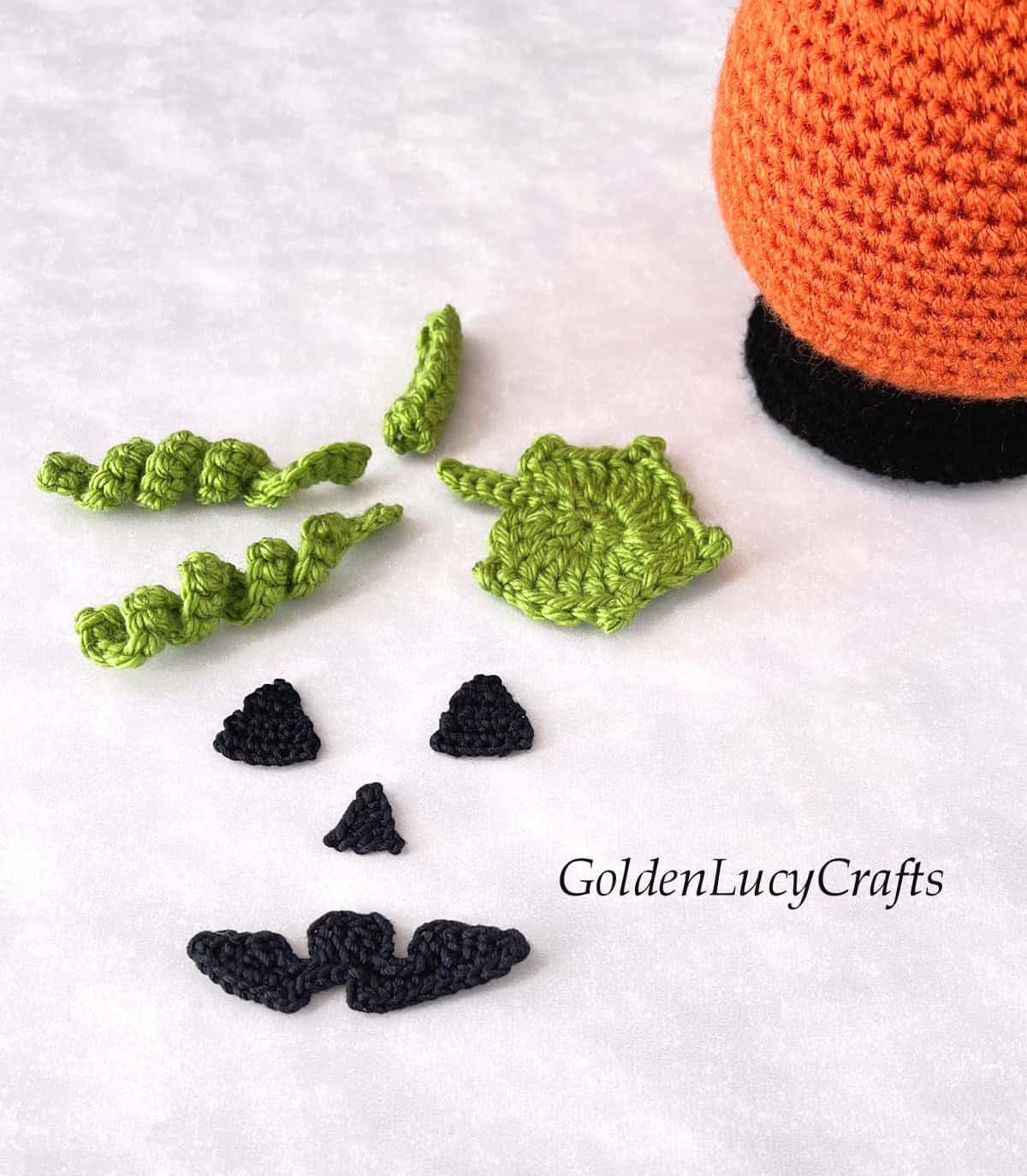 Crocheted face elements for the pumpkin snow globe.