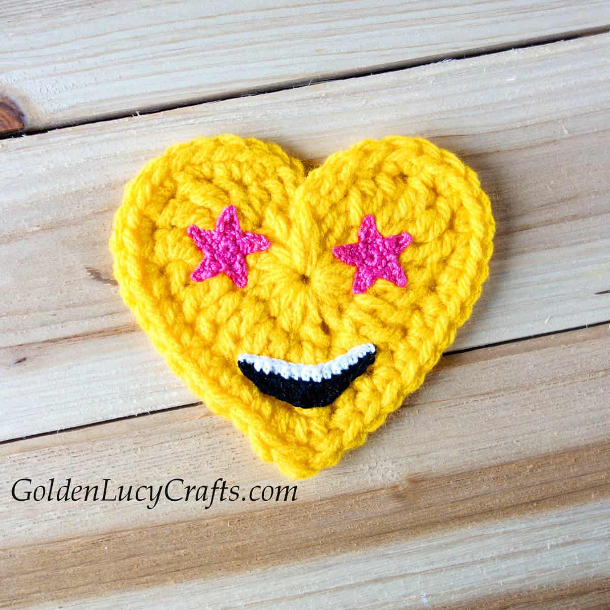 Crochet heart emoji with pink star eyes.