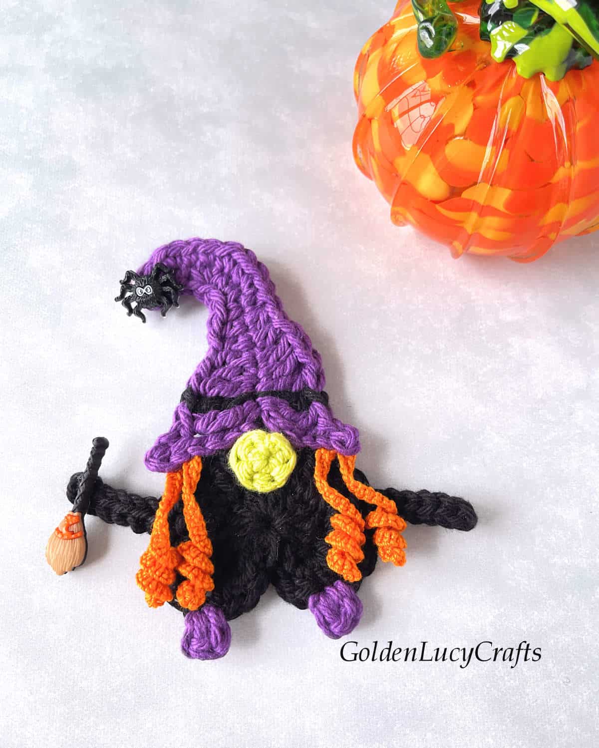 Crochet applique witch with broom.