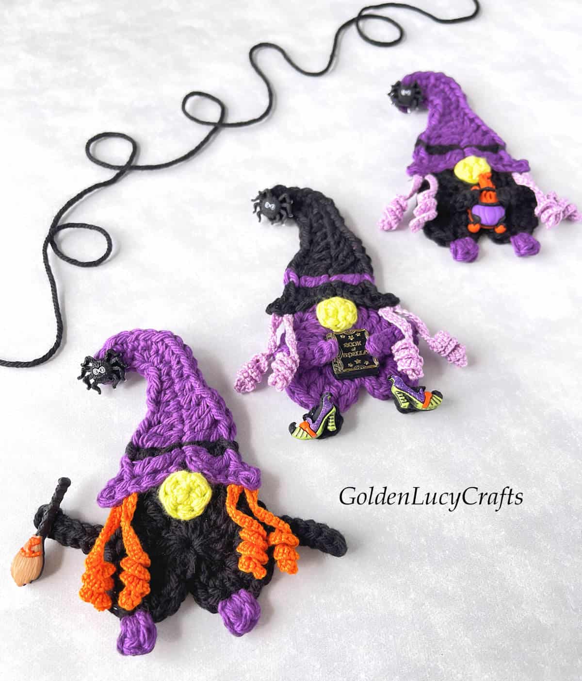 Three crocheted witch appliques.