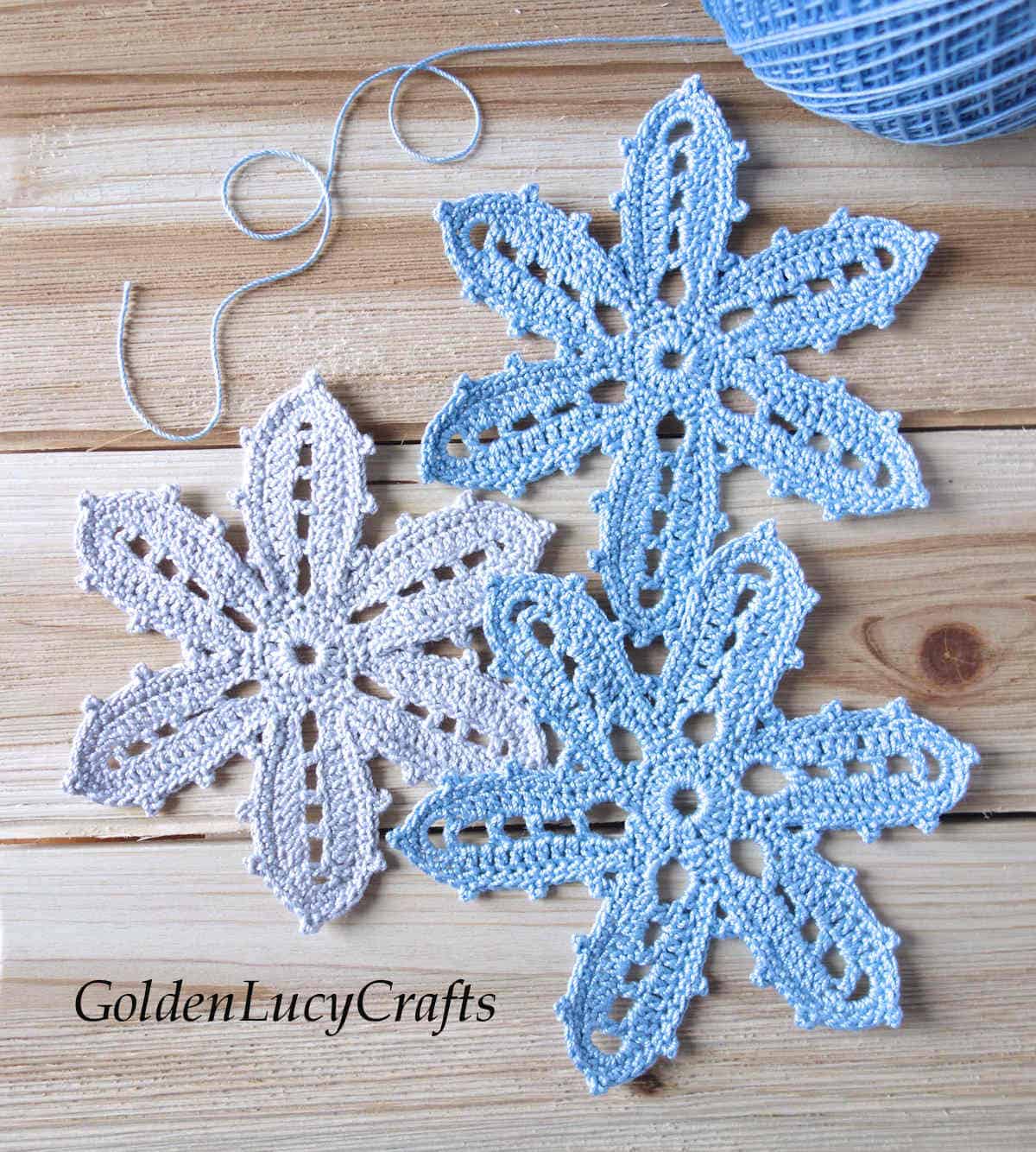 Three crocheted lacy flowers.