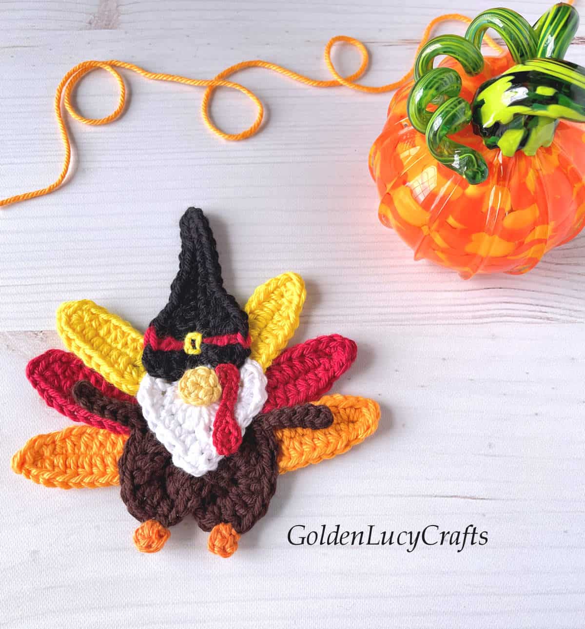 Crochet turkey gnome applique and a glass pumpkin.