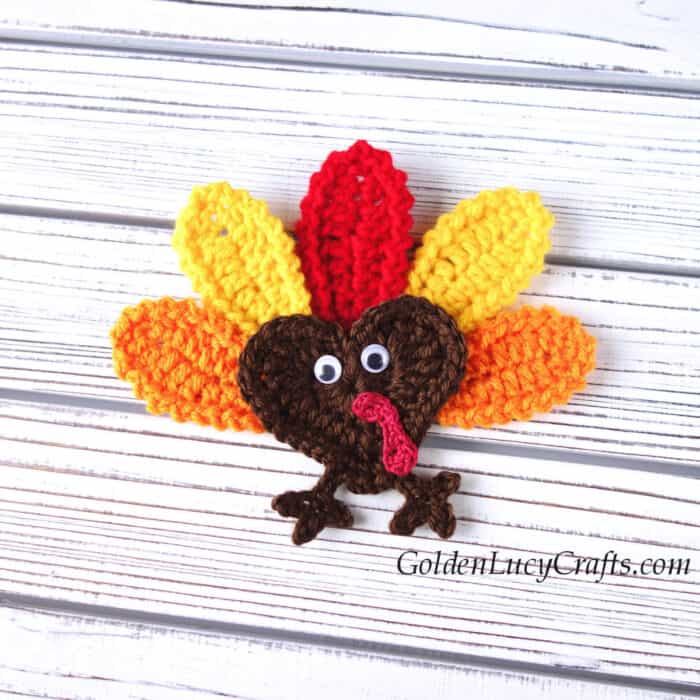 Crochet applique heart-shaped turkey.