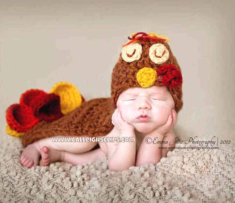Baby dressed in turkey costume.
