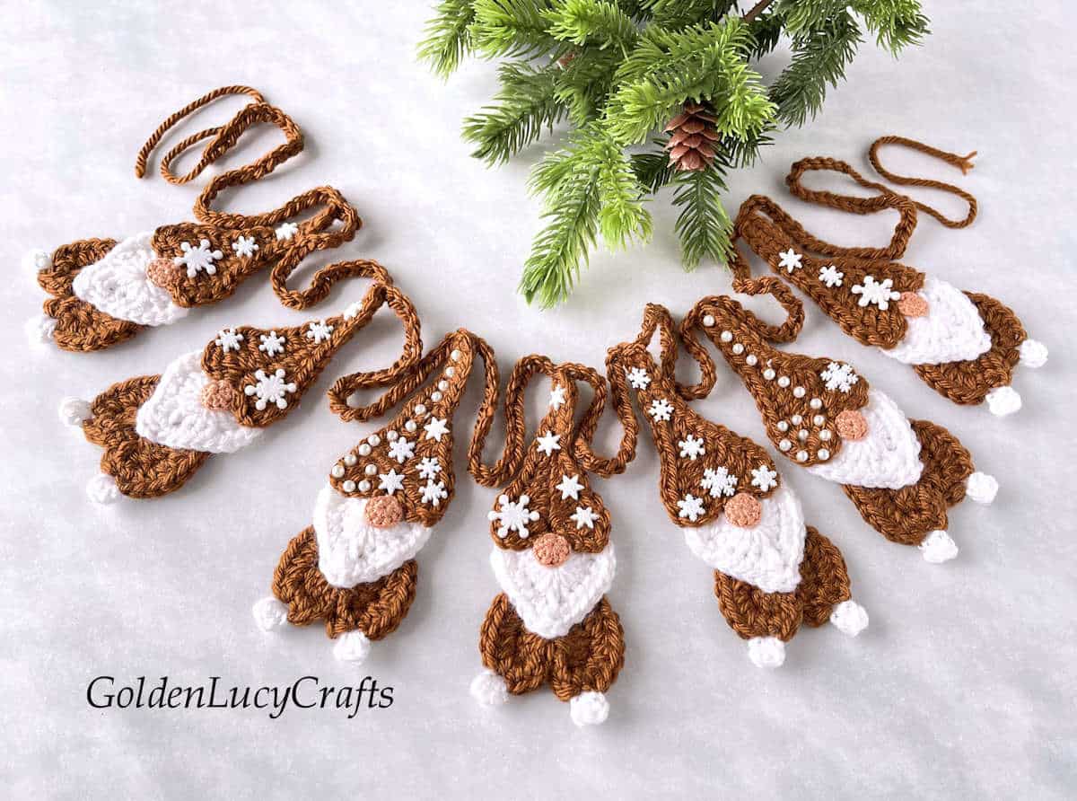 Crochet Christmas garland made from heart-shaped gingerbread gnomes.