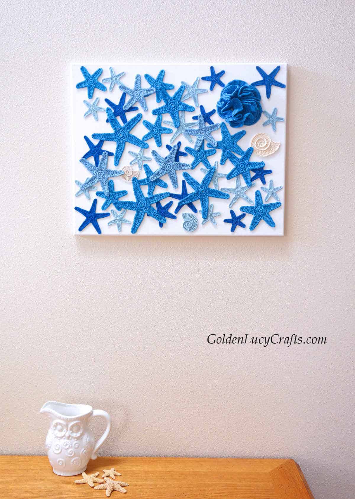 Crochet wall art, blue star fish and corals.