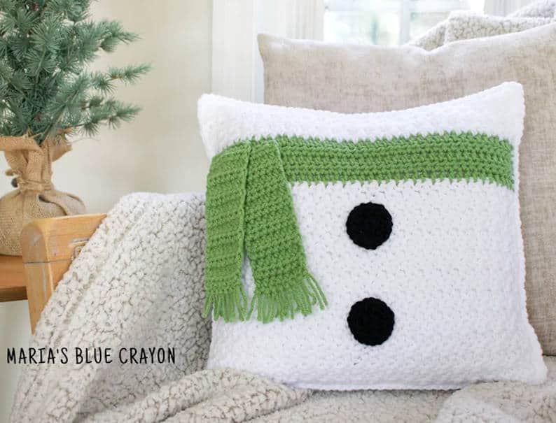 Crochet snowman-themed pillow.