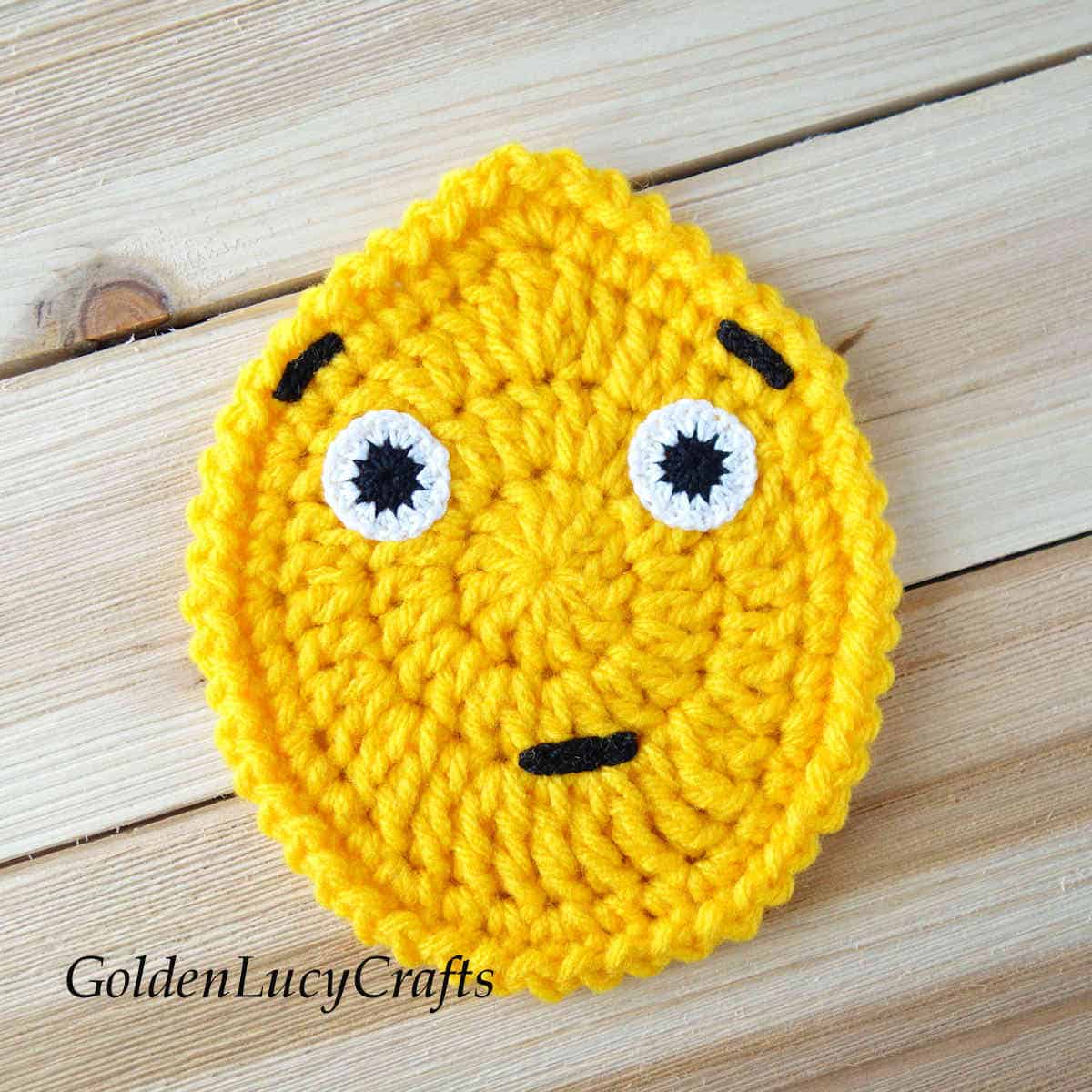 Crochet Easter egg emoji surprised face.