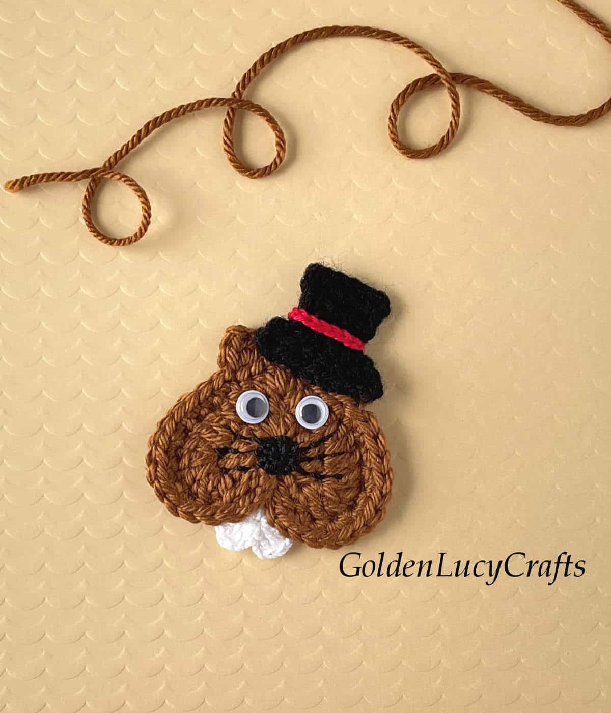 Crochet heart groundhog in a top hat.