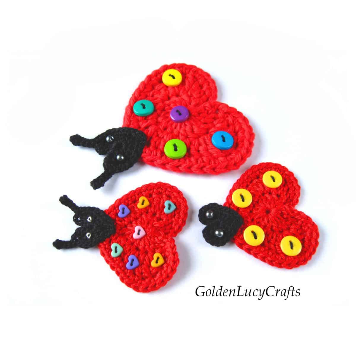 Three crocheted heart ladybugs.