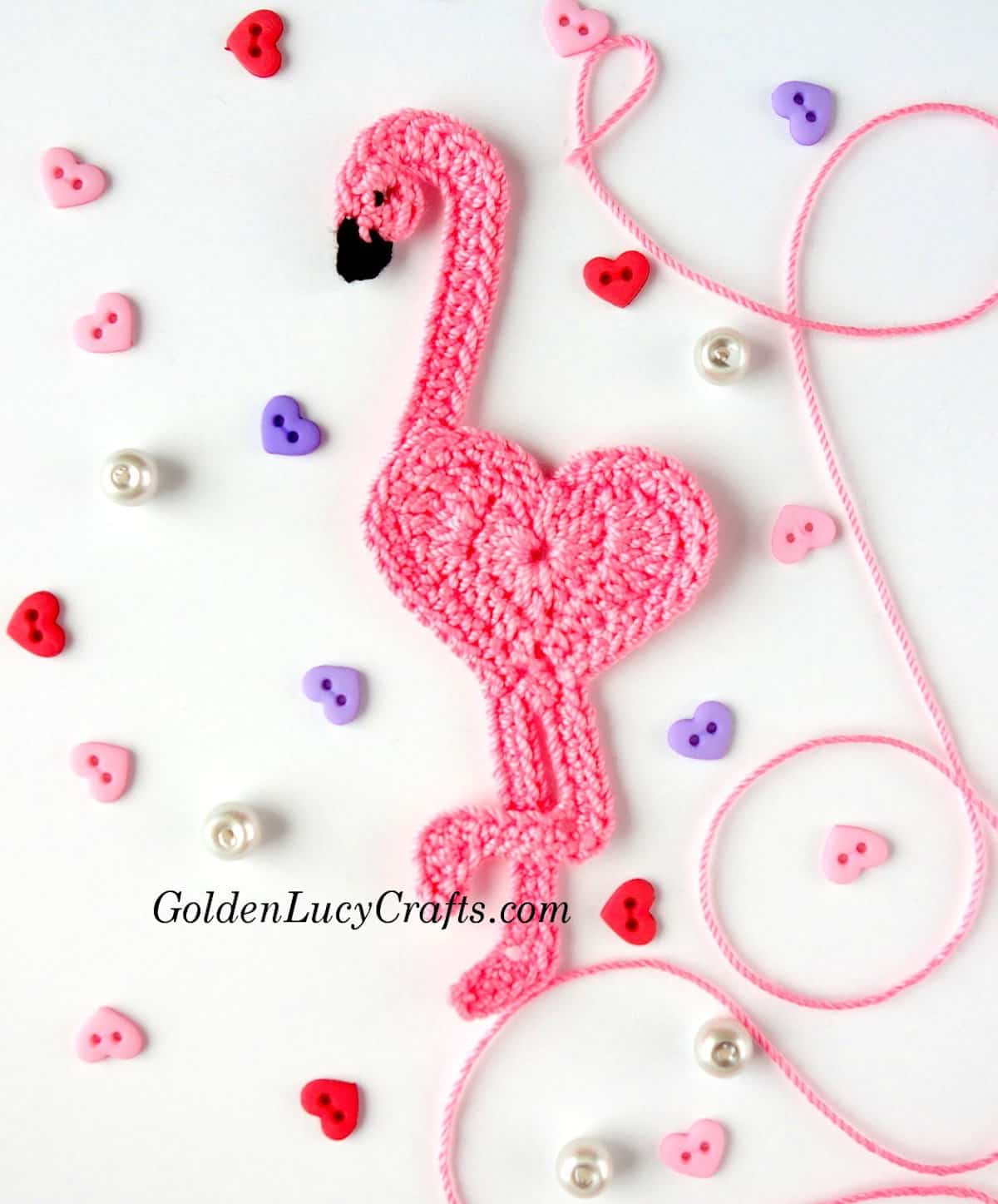 Crochet pink flamingo applique with heart-shaped body.