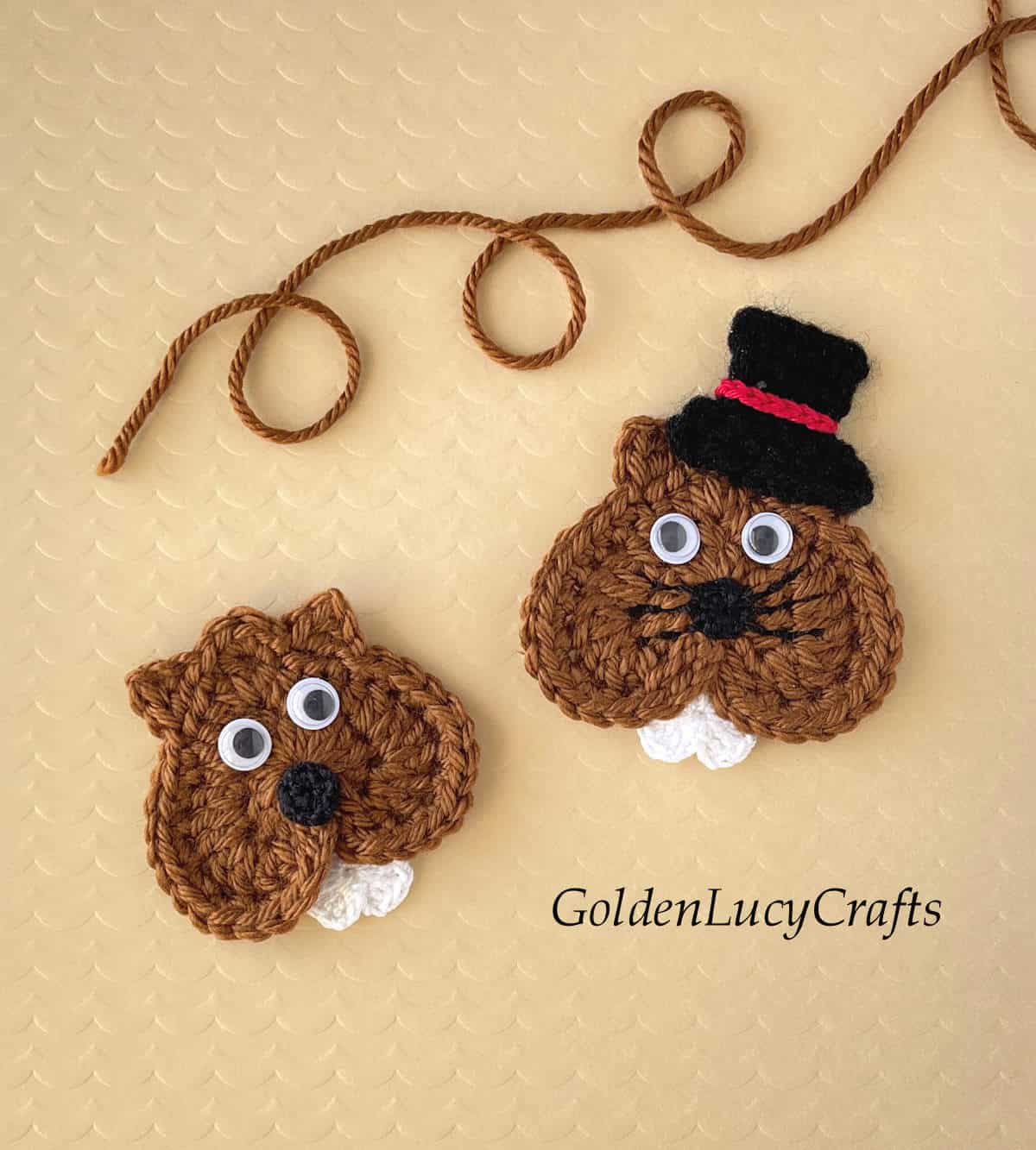 Two crochet groundhog appliques.