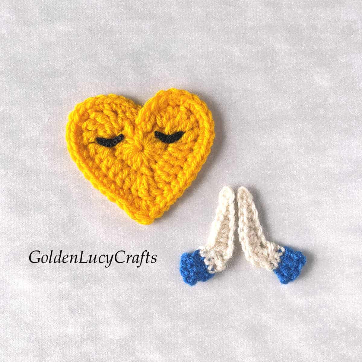 Crochet heart-shaped face and praying hands.