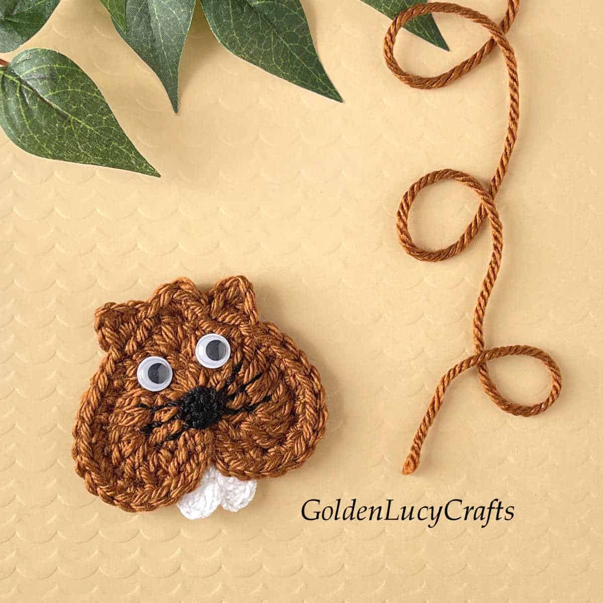 Heart-shaped groundhog crochet applique.