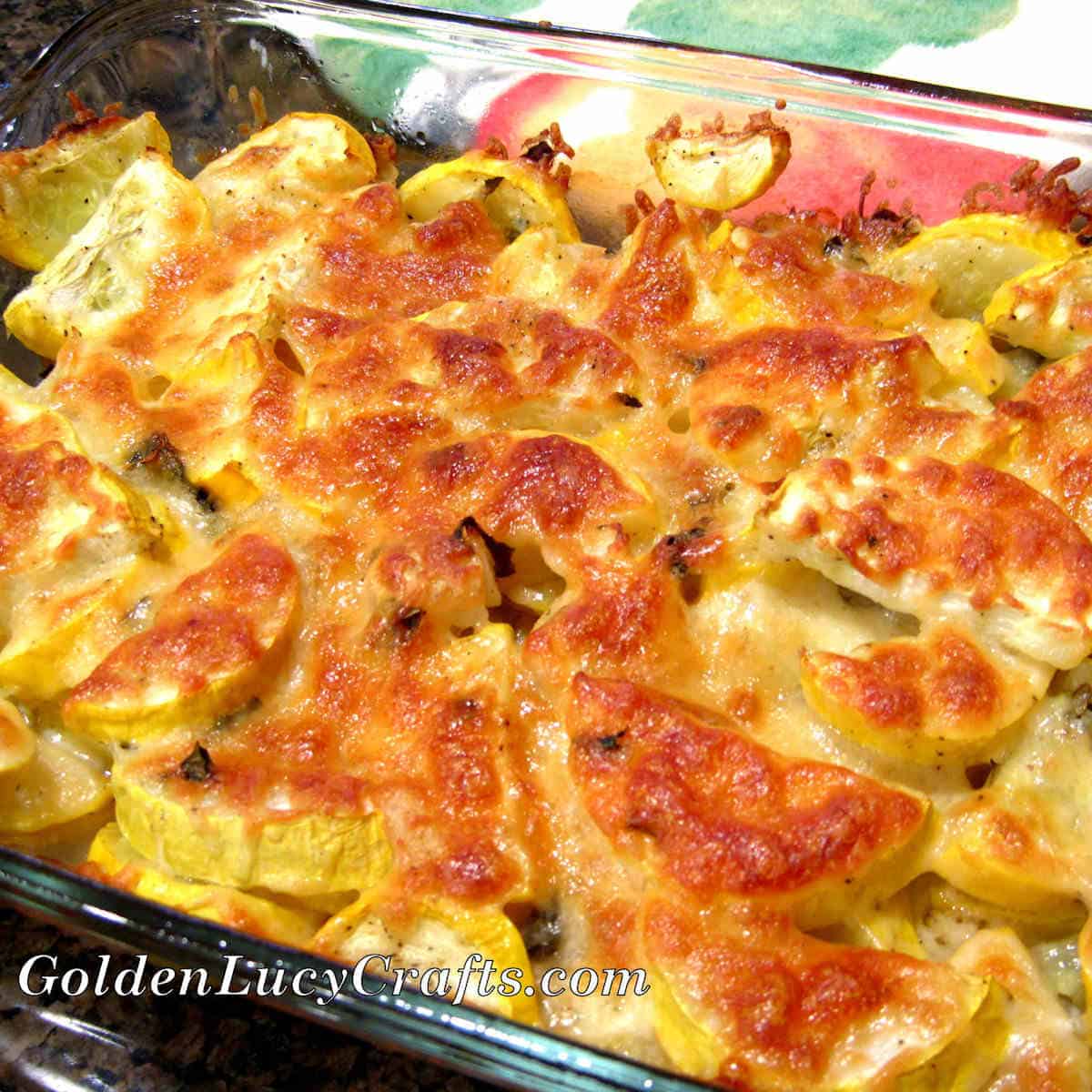 Baked yellow squash with cheese in baking dish.