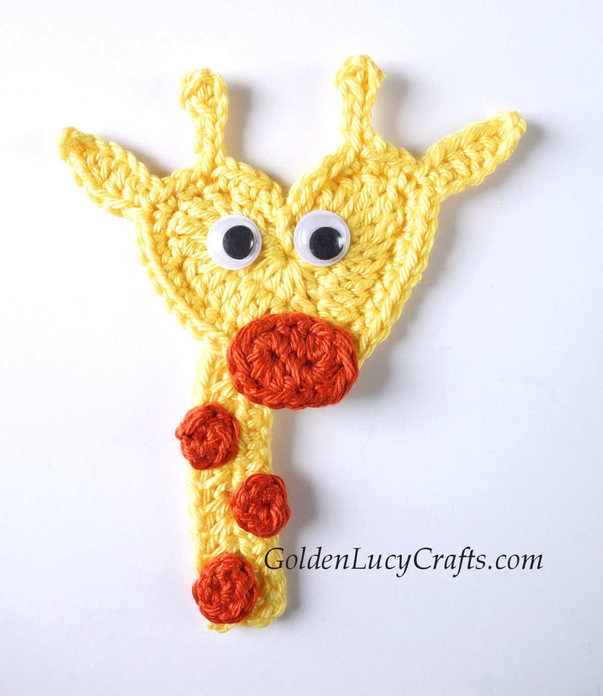 Crochet applique giraffe with heart-shaped head.