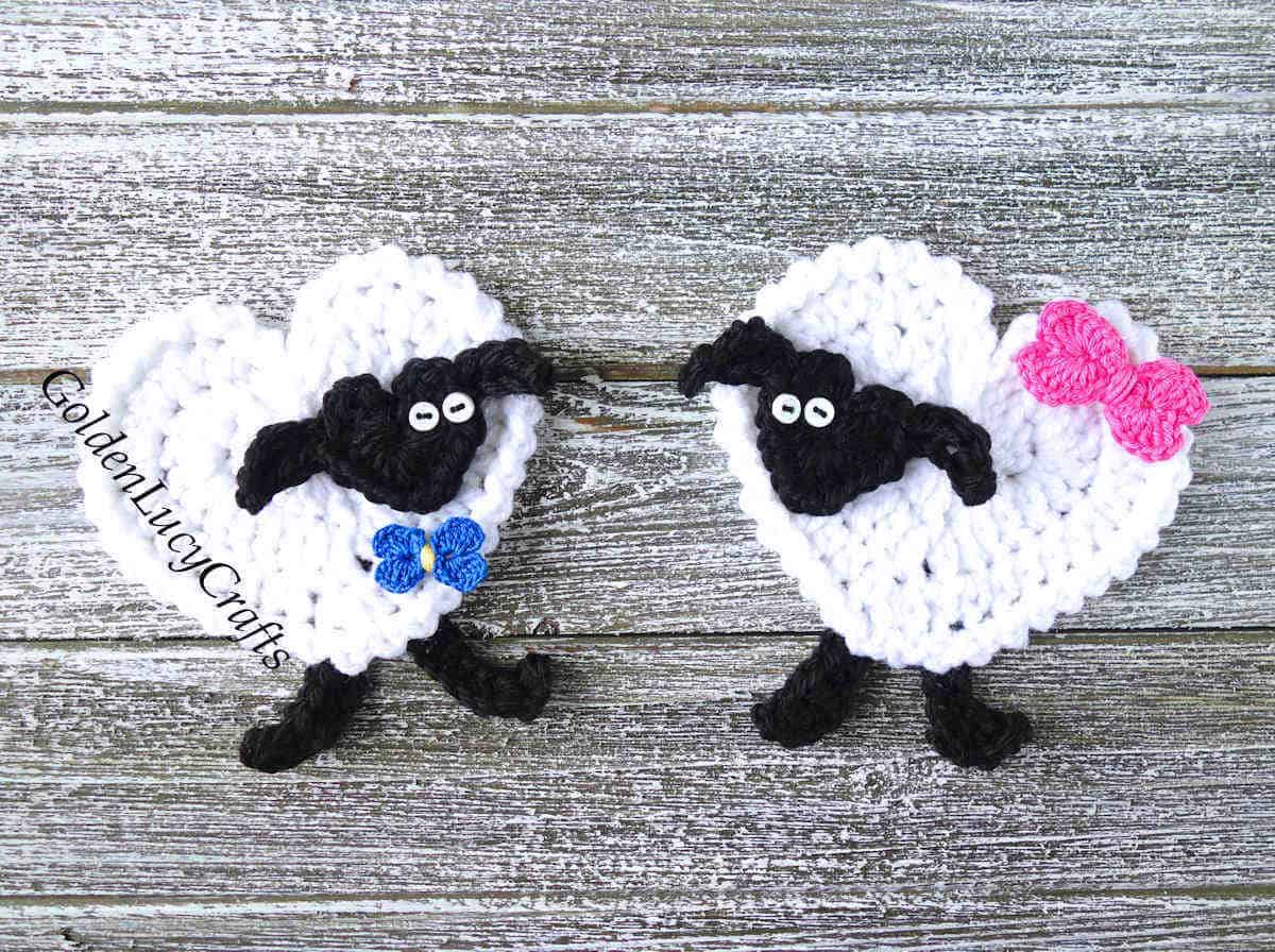 Two heart-shaped sheep crochet appliques.