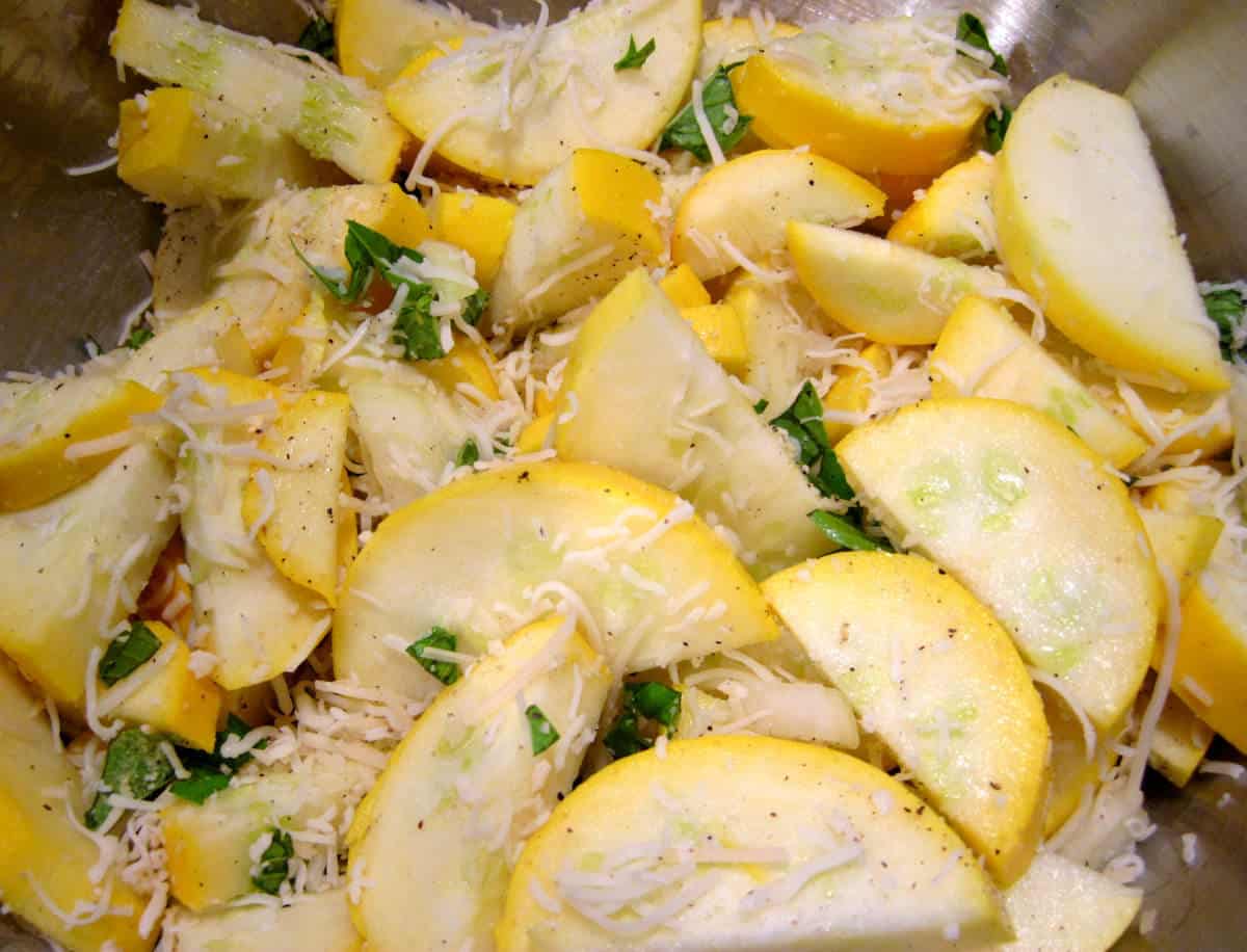 Sliced yellow squash mixed with cheese and basil.