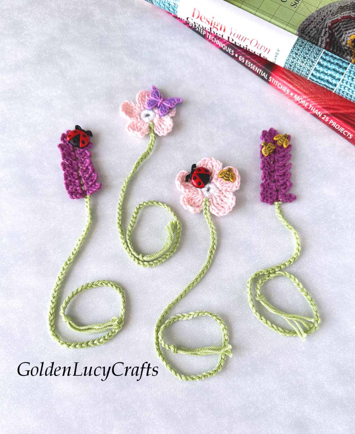 Four crochet flower bookmarks and books in the background.