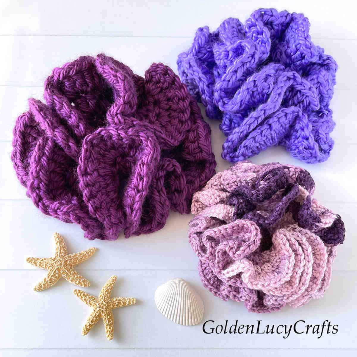 Three crocheted hyperbolic corals.