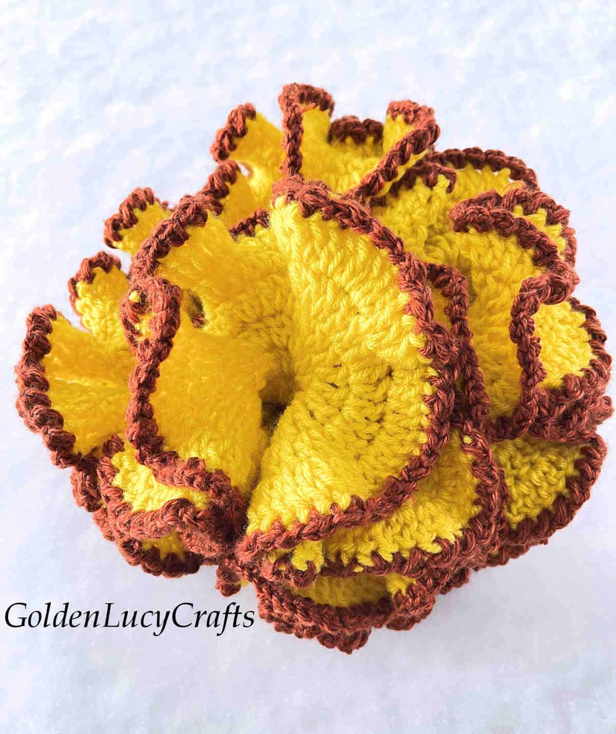 Yellow with brown edging crocheted hyperbolic coral.