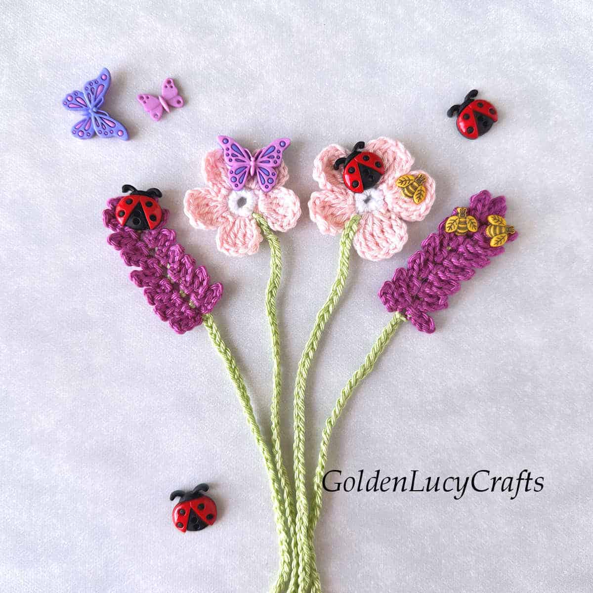 Two lavender crochet bookmarks and two cherry blossom crochet bookmarks embellished with craft buttons.