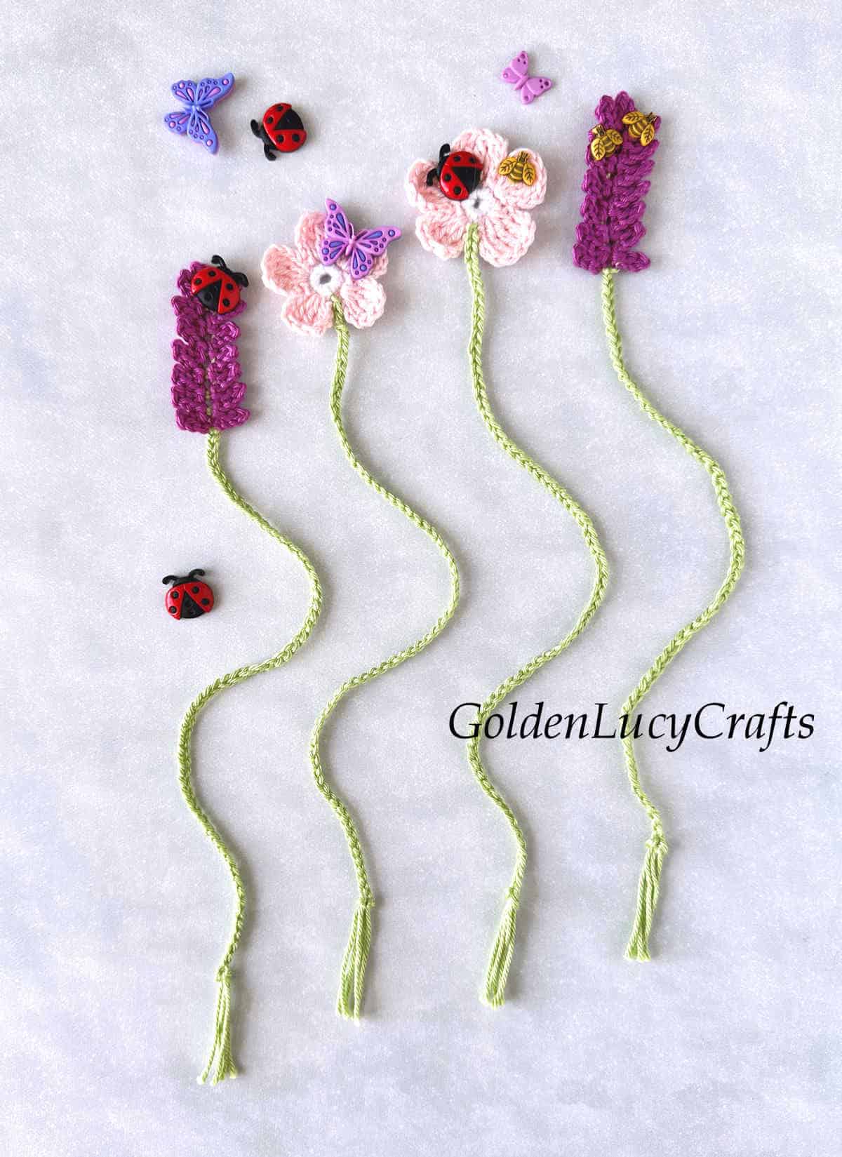 Four crocheted floral bookmarks.