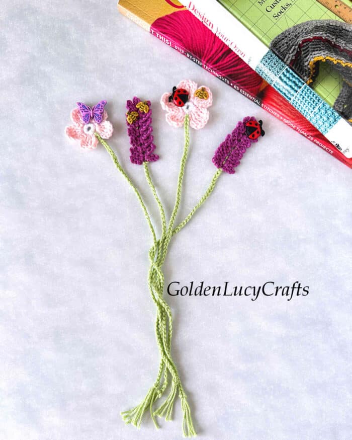 Crochet lavender and cherry blossom bookmarks embellished with craft buttons.