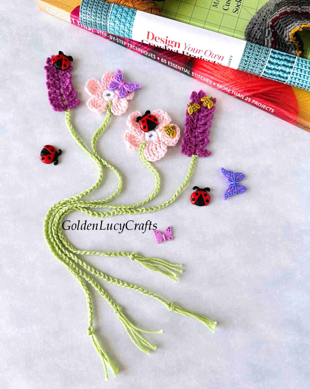 Crochet floral bookmarks embellished with craft buttons.