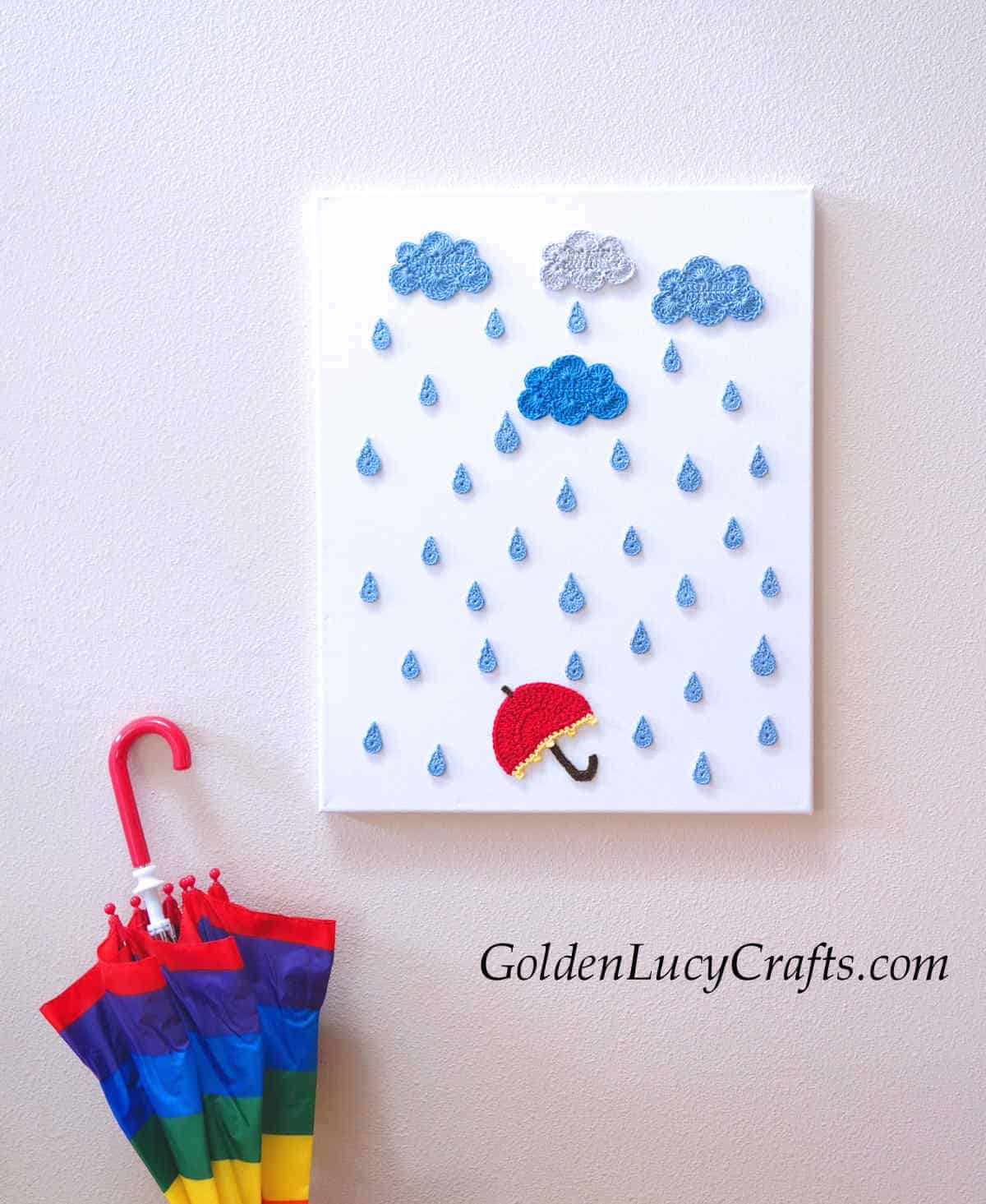 Rainy day wall art made from crocheted appliques.