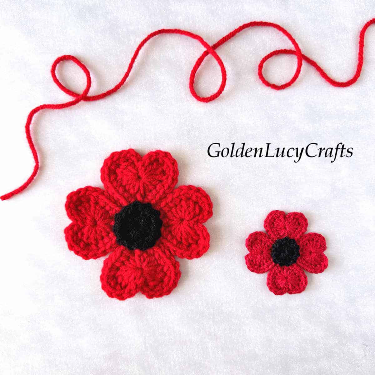 Large and small crocheted red poppy flowers.