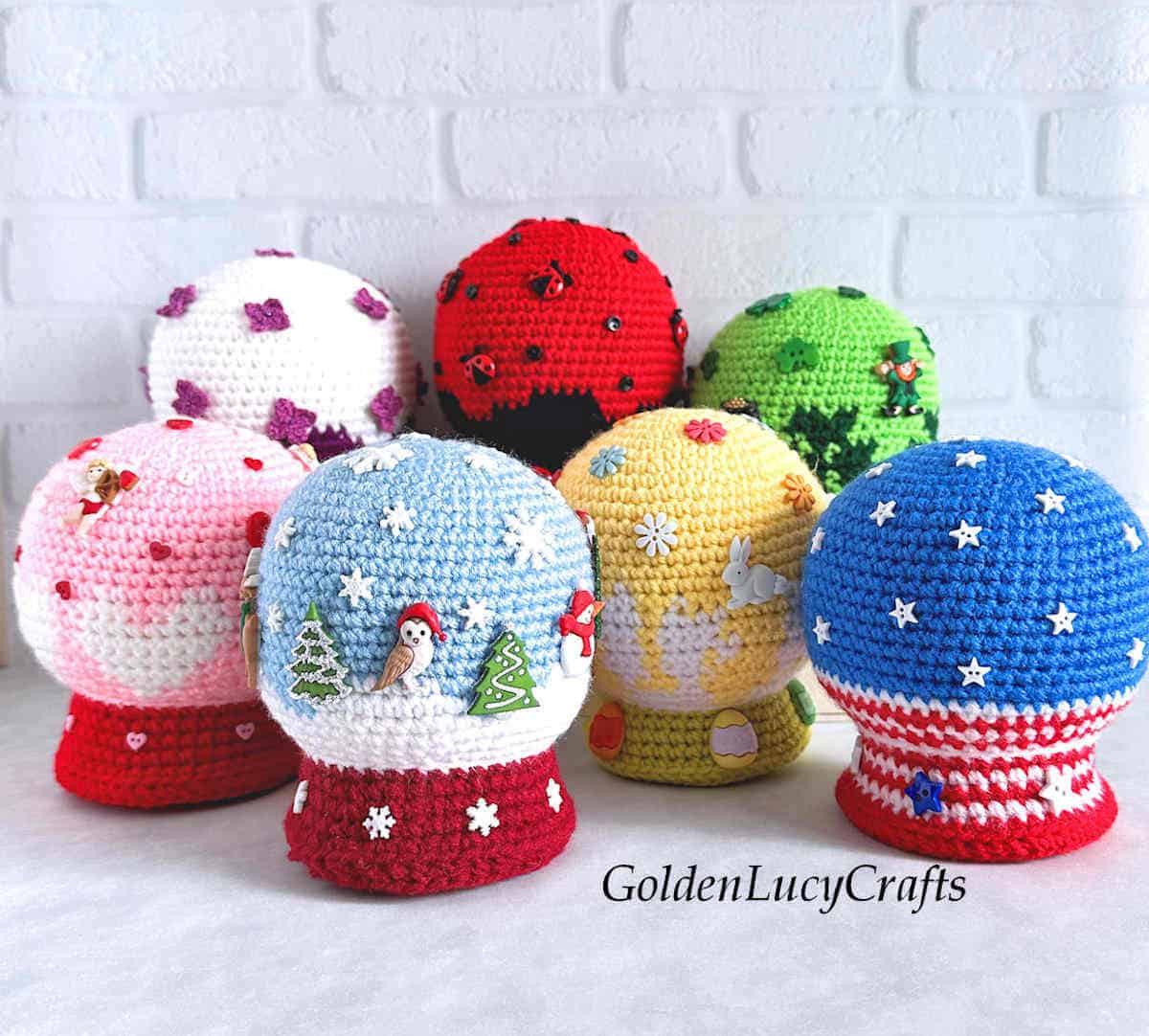 Seven crocheted snow globes amigurumi.