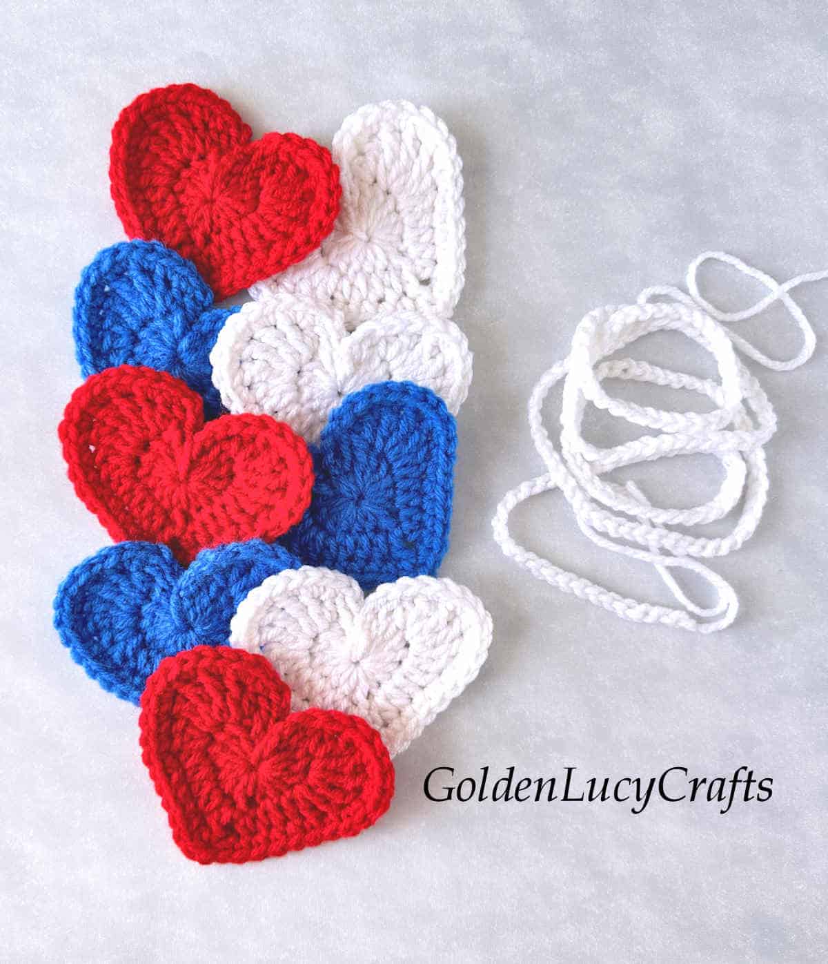 Red, white and blue crocheted hearts and crocheted string.