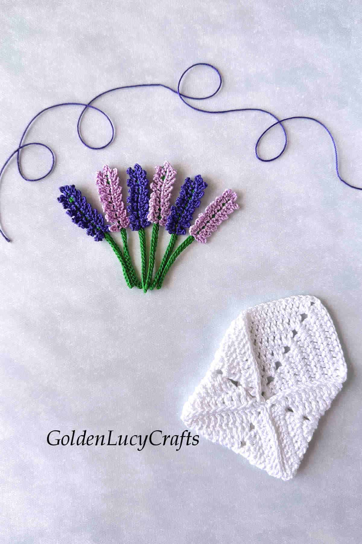 Crocheted white envelope and lavender flowers.