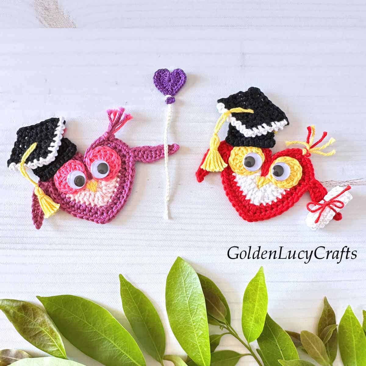 Two crochet graduation owls - owl with balloon, and owl with diploma.