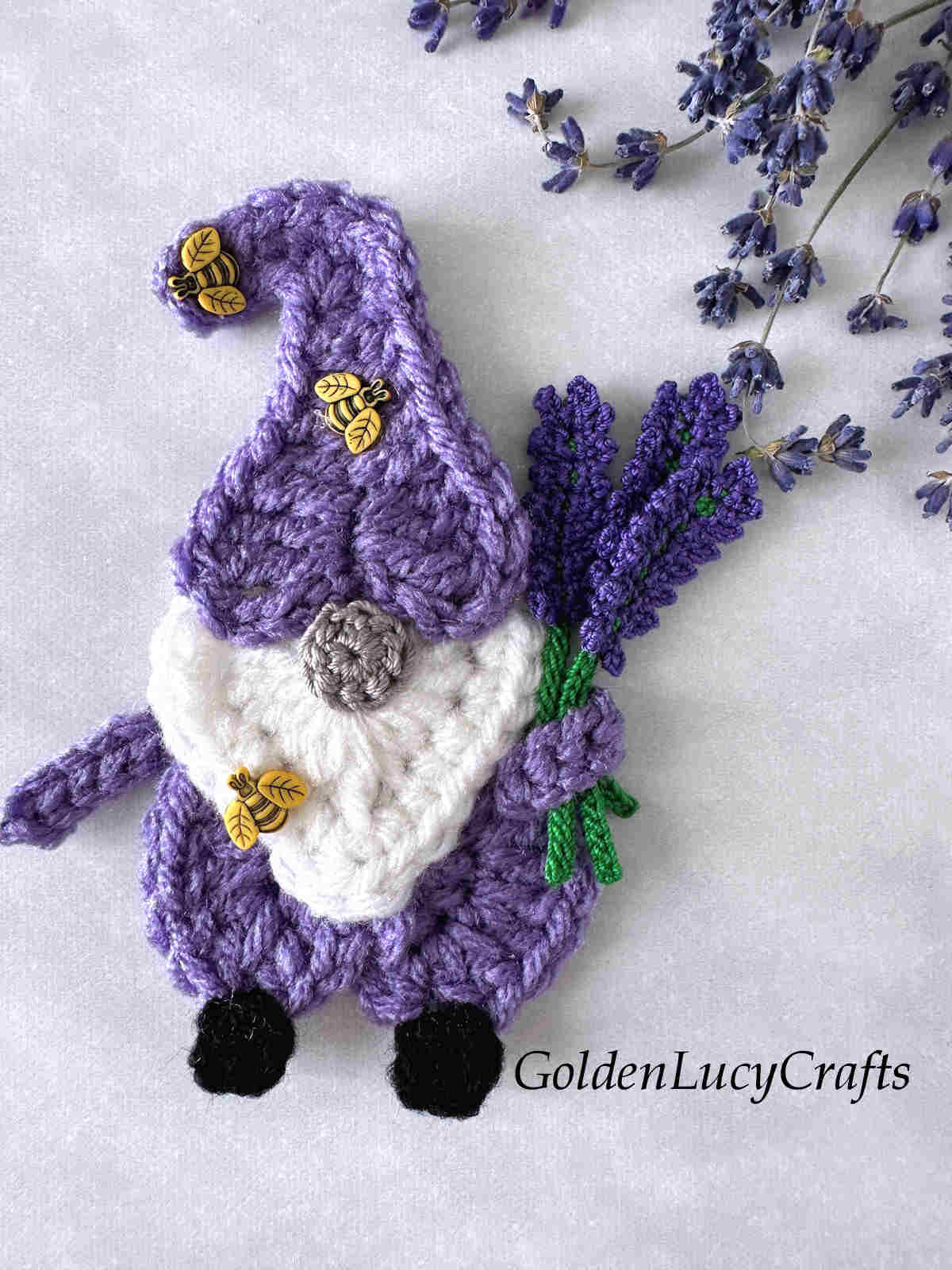 Crochet gnome with lavender bouquet.