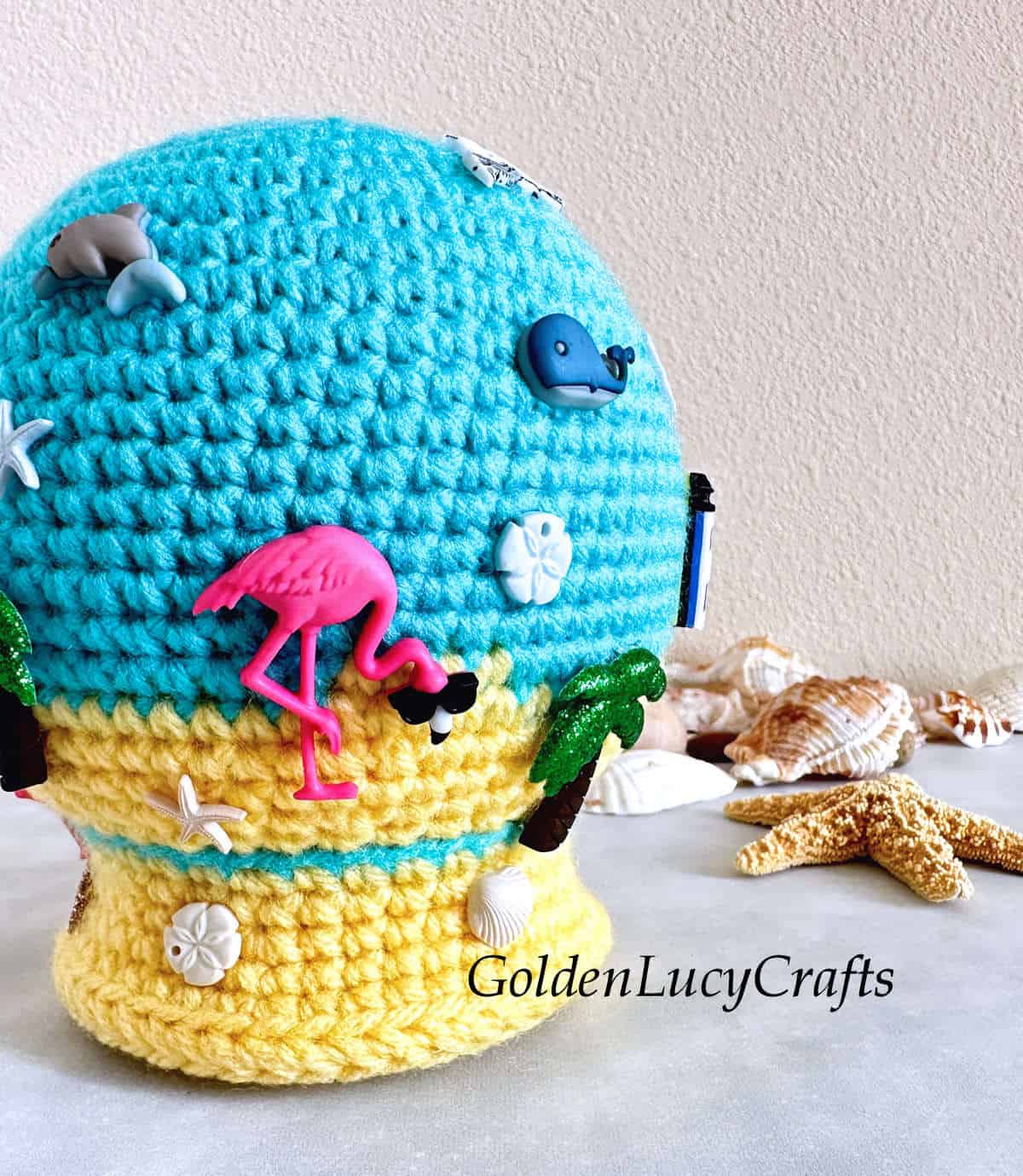 Crochet summer-themed snow globe close up picture.