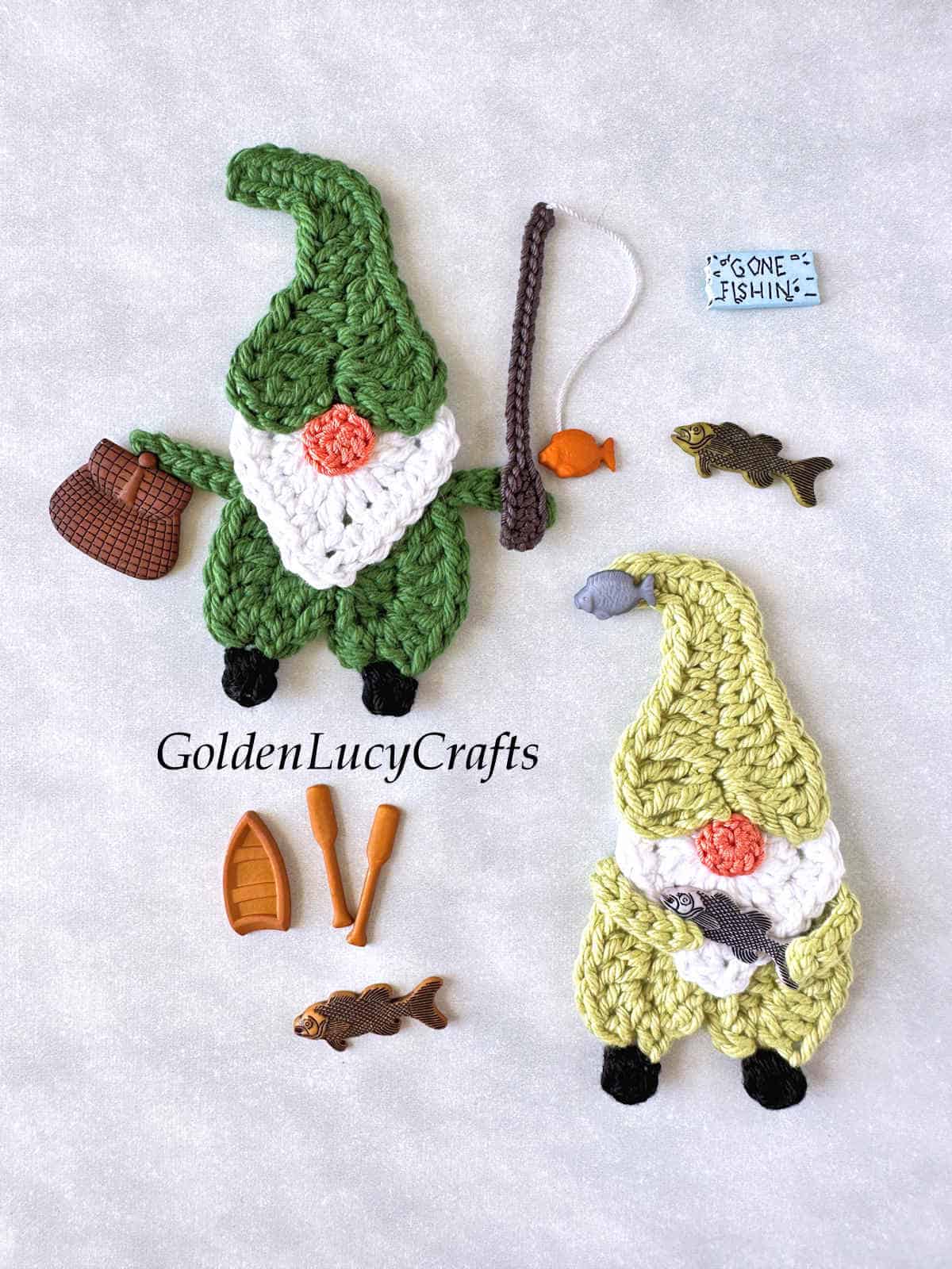 Two crocheted fishing gnomes and fishing-themed craft buttons.