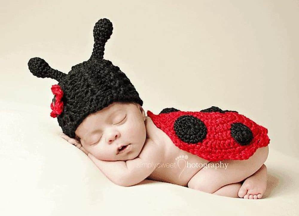 Sleeping baby dressed in ladybug costume.