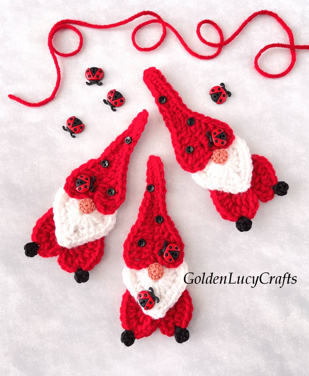 Three crochet ladybug-themed gnomes.