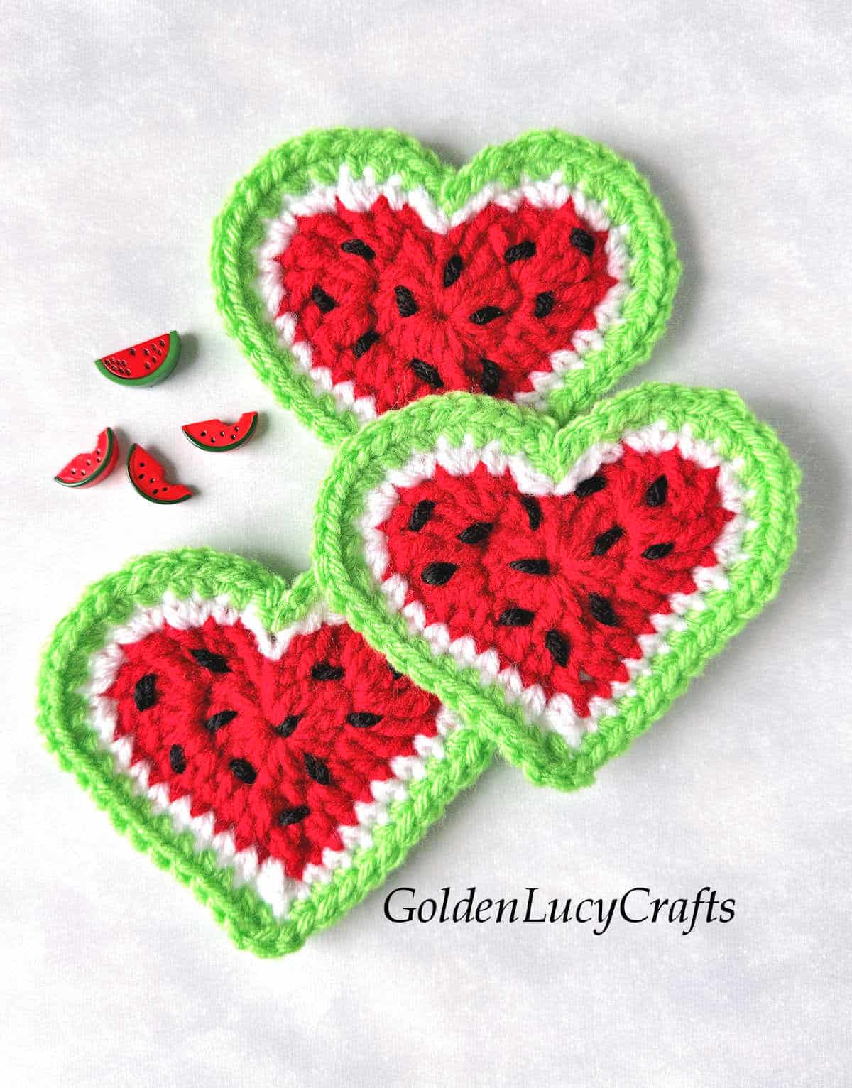 Three crochet watermelon hearts and four watermelon craft buttons.