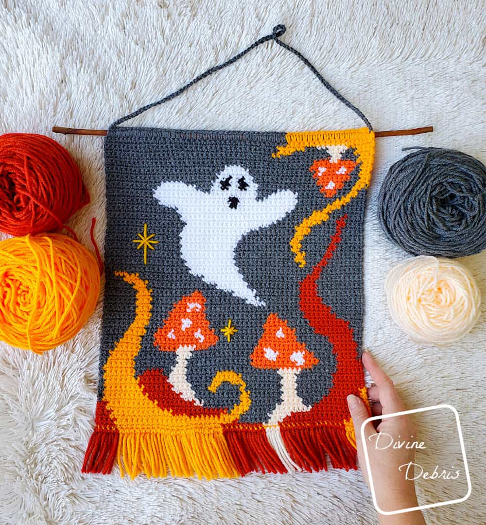 Crochet walkl hangning with ghost and mushrooms.