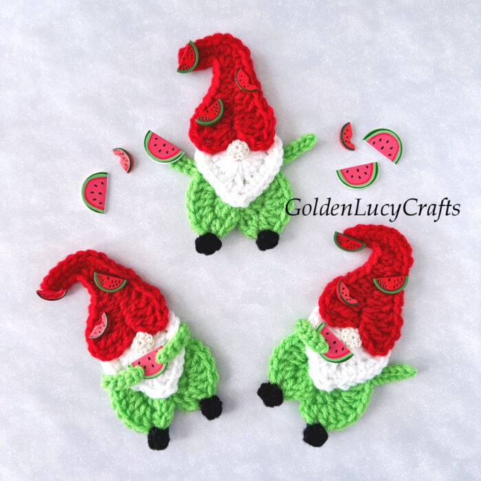Three crocheted watermelon gnomes and watermelon craft buttons.