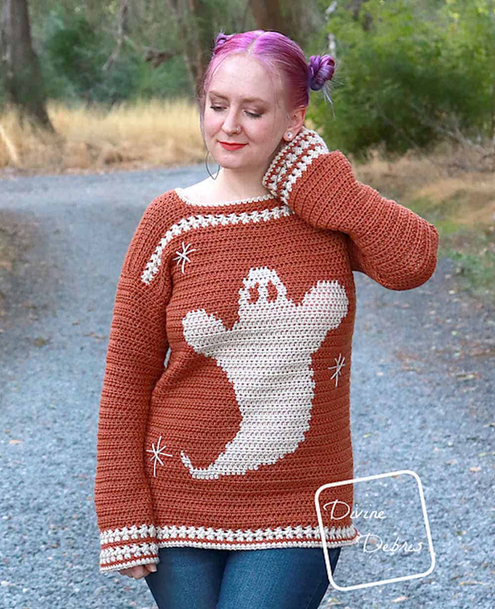 Model dressed in sweater with a ghost on front of it.