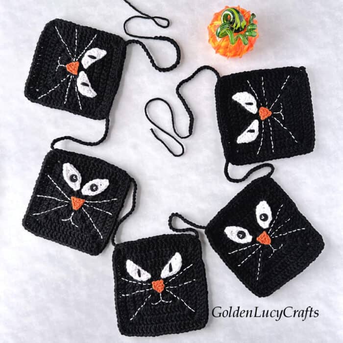 Crocheted Halloween black cat garland.