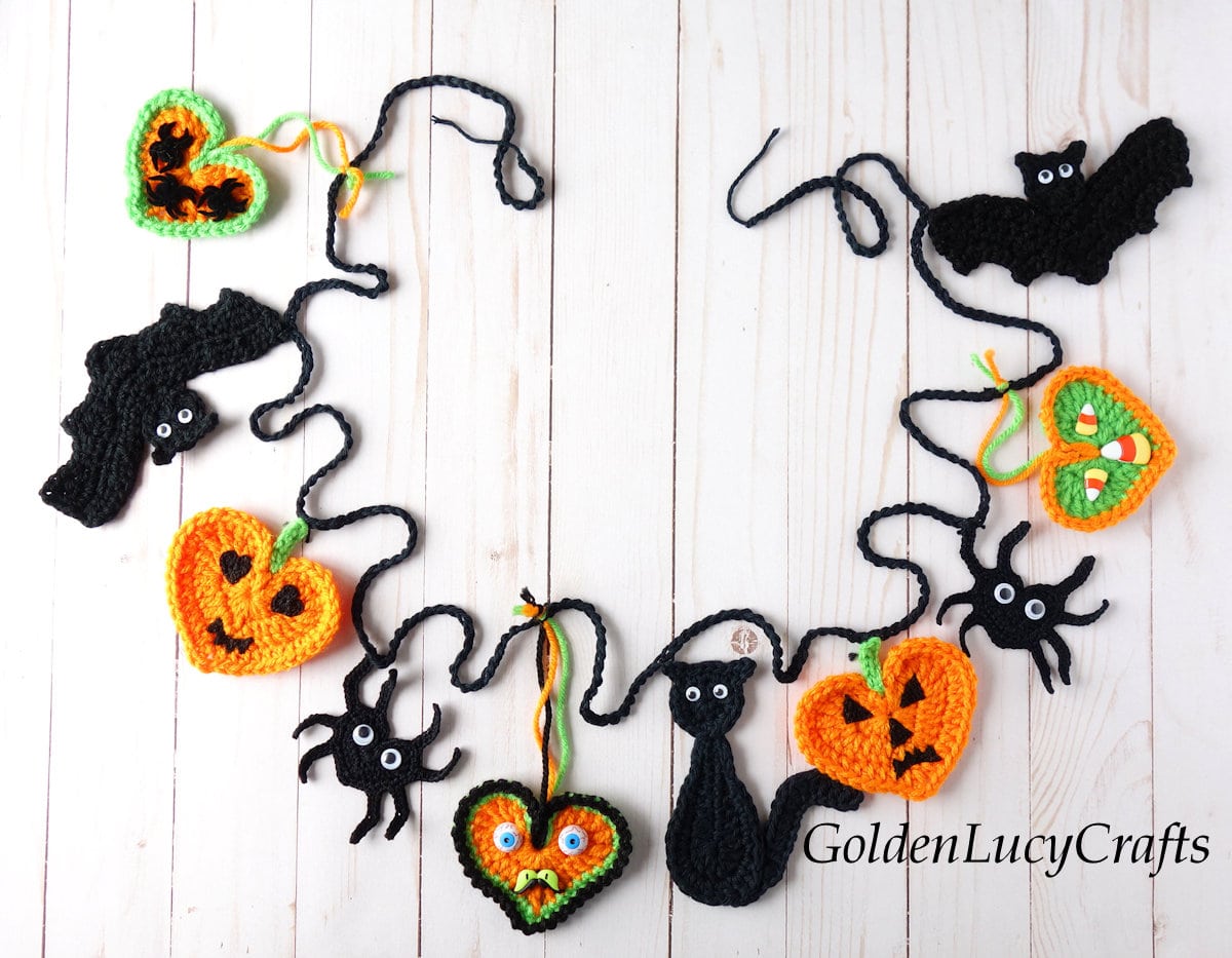 Crocheted Halloween garland made of crochet cats, bats and hearts appliques.