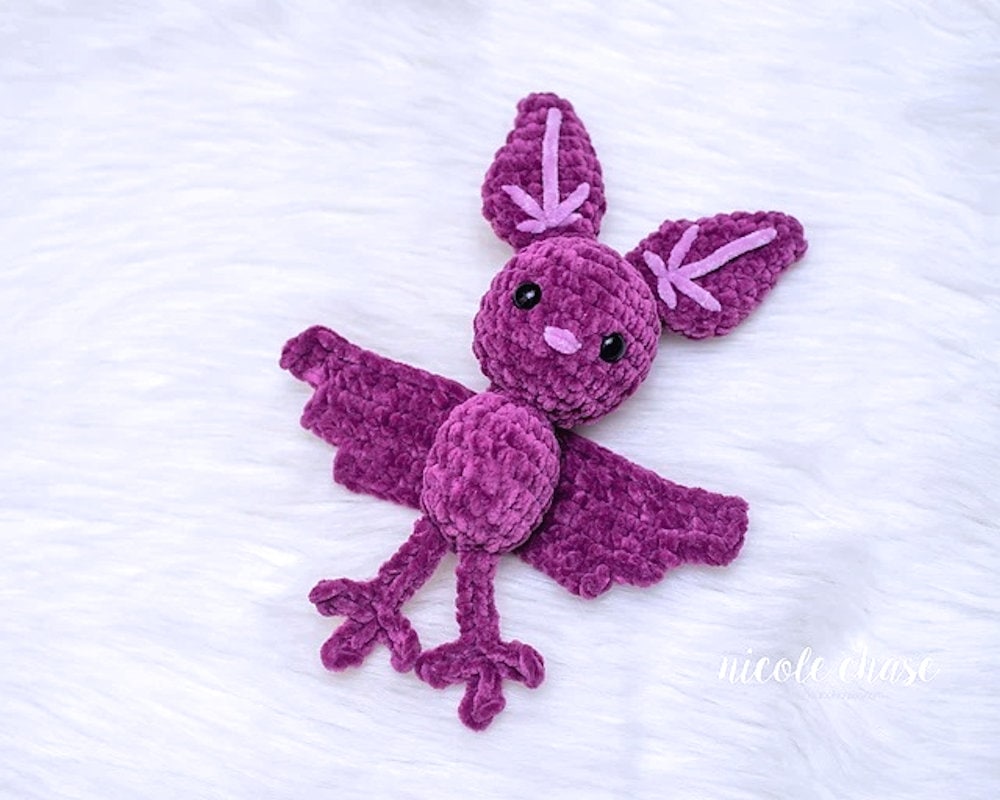 Crocheted purple bat amigurumi.